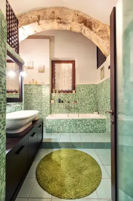 a bathroom with a tub and a sink at Vista Cattedrale in Palermo