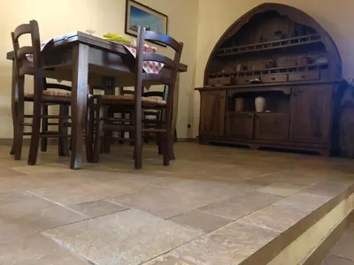 a dining room with a table and two chairs and a table and a counter at Agriturismo Ilardo in Collesano