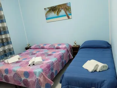a bedroom with two beds with towels on them at casaLiuccia in Mondello