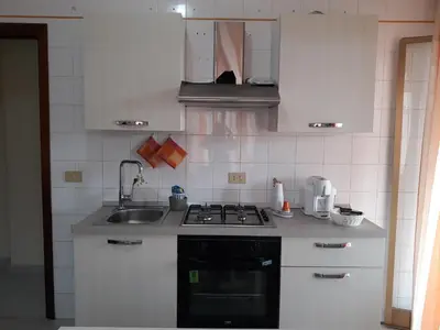 a kitchen with a sink and a stove top oven at casaLiuccia in Mondello