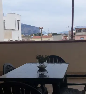 a table with a vase on it on a balcony at casaLiuccia in Mondello