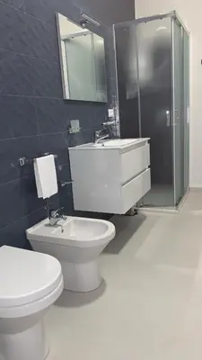 a bathroom with a toilet and a sink and a shower at Dependance La Mouette in Termini Imerese