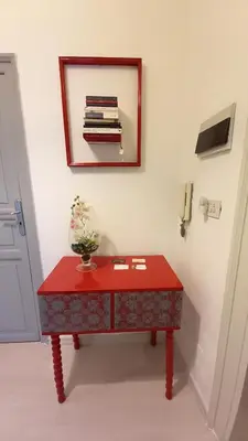 a red table in a room with a mirror at Palazzo Cutelli Bed&Book in Palermo