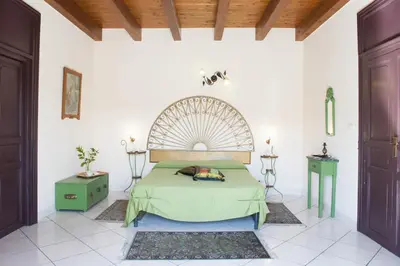 a bedroom with a large bed in a room at Case D'Anna in Castellammare del Golfo