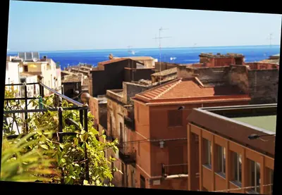a bedroom with a bed and a desk and a chair at Case D'Anna in Castellammare del Golfo