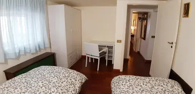 a small bedroom with two beds and a desk at Casa de Spuches in Palermo