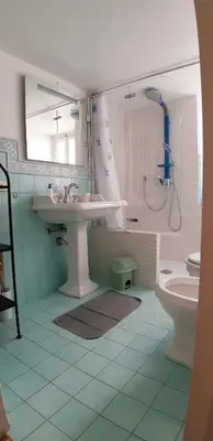a bathroom with a sink and a toilet and a mirror at Casa de Spuches in Palermo
