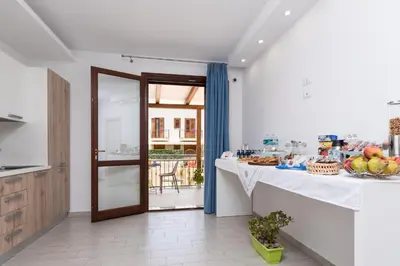 a kitchen with a table with a bowl of fruit at B&B Reset confort & relax in San Vito lo Capo