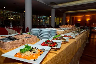 a long table with plates of food on it at Hotel Torre Normanna in Altavilla Milicia