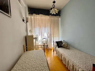 a bedroom with two beds and a window at Sea Pearl in Casteldaccia