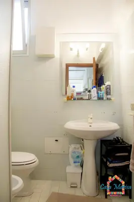 a bathroom with a sink and a toilet and a mirror at Casa Marisa in Palermo
