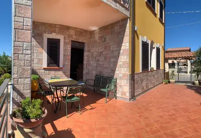 a patio with a table and chairs on a building at Simo Amour in Lercara Friddi