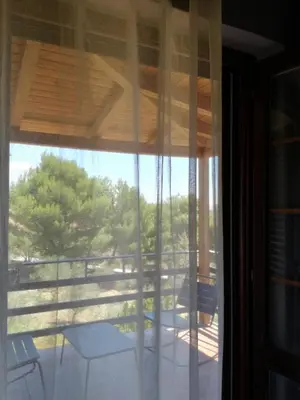 a view from a glass door of a porch with a view at Simo Amour in Lercara Friddi