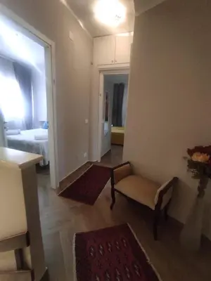 a living room with a chair and a bedroom at Simo Amour in Lercara Friddi