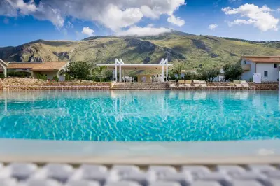 a swimming pool with a mountain in the background at Borgo Aranci - Appartamento in Villa Rosa - 16B in Castellammare del Golfo