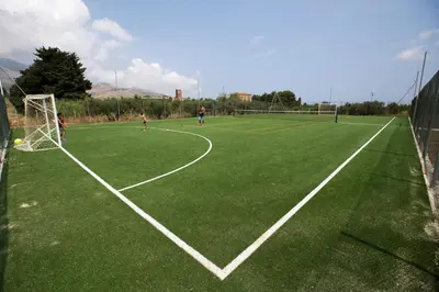 a group of people playing soccer on a soccer field at Borgo Aranci - Appartamento in Villa Rosa - 16B in Castellammare del Golfo