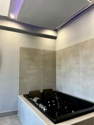 a black bath tub in a room with at Cannatella's Mansion in Palermo