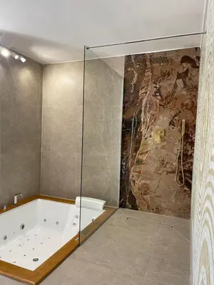 a bathroom with a shower with a bath tub at Cannatella's Mansion in Palermo