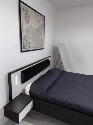 a bedroom with a bed and a picture on the wall at Cannatella's Mansion in Palermo