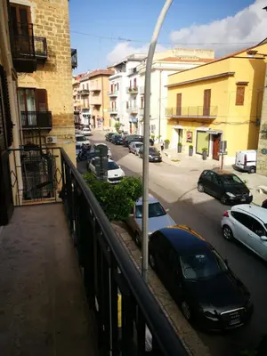 a view of a parking lot with cars parked on a street at Si Viaggiare Apartments in Partinico