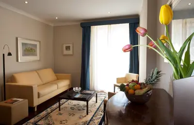 a living room with a couch and a table at Hotel Giardino Inglese in Palermo
