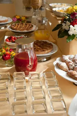 a table topped with plates of food and desserts at Hotel Giardino Inglese in Palermo