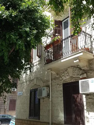 a building with a balcony and a window and a door at B&B SAMMARTINO in Palermo