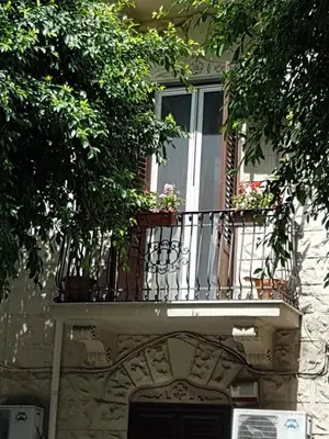 a balcony on a building with potted plants on it at B&B SAMMARTINO in Palermo