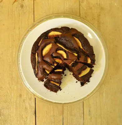 a chocolate cake on a plate on a wooden table at Ai Vicerè in Palermo