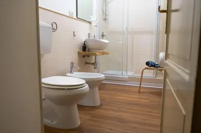 a bathroom with a toilet and a sink and a shower at Ai Vicerè in Palermo