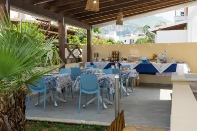a restaurant with blue tables and chairs and a counter at La Dimora del Pescatore in San Vito lo Capo