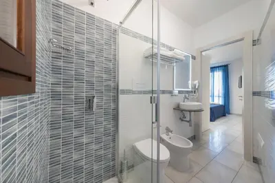 a bathroom with a toilet and a glass shower at La Dimora del Pescatore in San Vito lo Capo