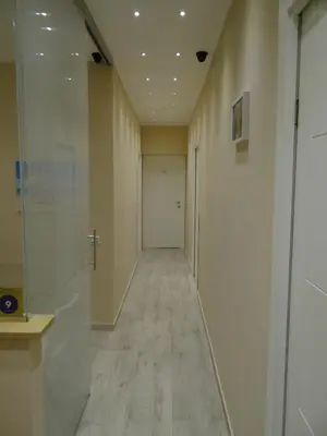 a hallway with a long corridor with a white door at Monte Palace Palermo in Palermo
