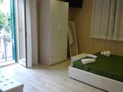 a bedroom with a bed and a large window at Monte Palace Palermo in Palermo