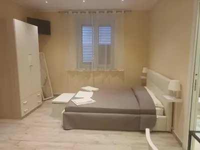 a bedroom with a large bed and a window at Monte Palace Palermo in Palermo