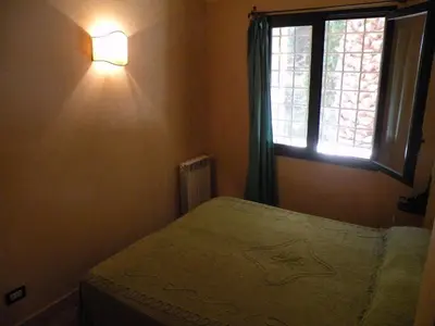 a bedroom with a bed and a window at the ancient sicilian house near zingaro reserve Scopello in Scopello