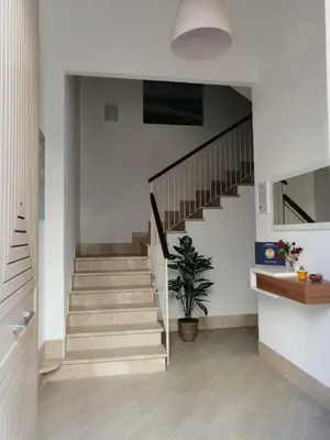 a staircase in a house with a potted plant at Le Sette Meraviglie in Castellammare del Golfo