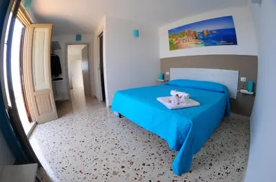 a bedroom with a blue bed with two stuffed animals on it at Le Sette Meraviglie in Castellammare del Golfo
