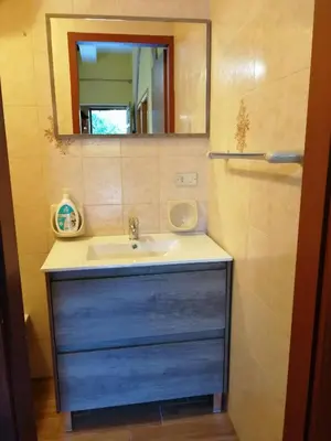 a bathroom with a sink and a mirror at House Cefalù 1915 in Lascari
