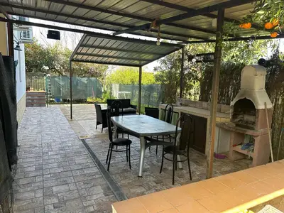 a patio with a table and an outdoor oven at House Cefalù 1915 in Lascari