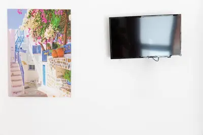a television in a room with blue and white buildings at Fuga Romantica vicino al Mare - Rental BeB in Balestrate