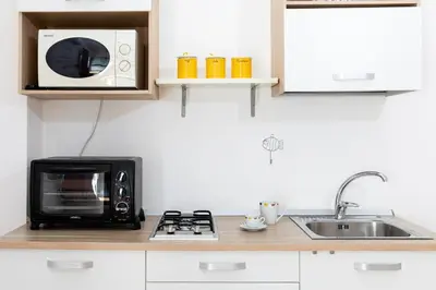 a microwave oven sitting on top of a kitchen counter at Fuga Romantica vicino al Mare - Rental BeB in Balestrate