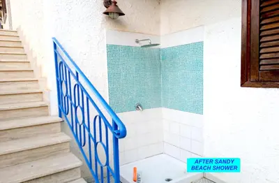 a bathroom with a blue and white shower and stairs at VILLASEASICILY , POOL SALT WATER and NATURAL CHLORINE IN BALESTRATE - PALERMO in Balestrate