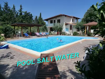 a swimming pool in front of a villa at VILLASEASICILY , POOL SALT WATER and NATURAL CHLORINE IN BALESTRATE - PALERMO in Balestrate
