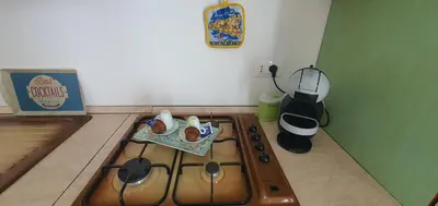 a kitchen with a stove top oven and a stove top at Loft in Balestrate vicino al Mare - Rental BeB in Balestrate