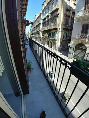 a view from a balcony of a street with buildings at Cassaro Antico in Palermo