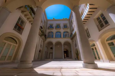 an empty courtyard of a building with columns at B&B Dimora Tomasi in Palermo