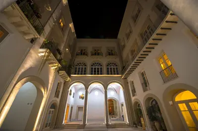 an empty building with arches and windows at night at B&B Dimora Tomasi in Palermo