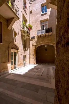an empty alley in an old building with a balcony at B&B Dimora Tomasi in Palermo
