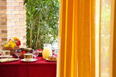 a red table with food and drinks on it at Al Lago Verde in Alia